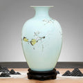 Full view of porcelain vase on wooden stand in a styled setting