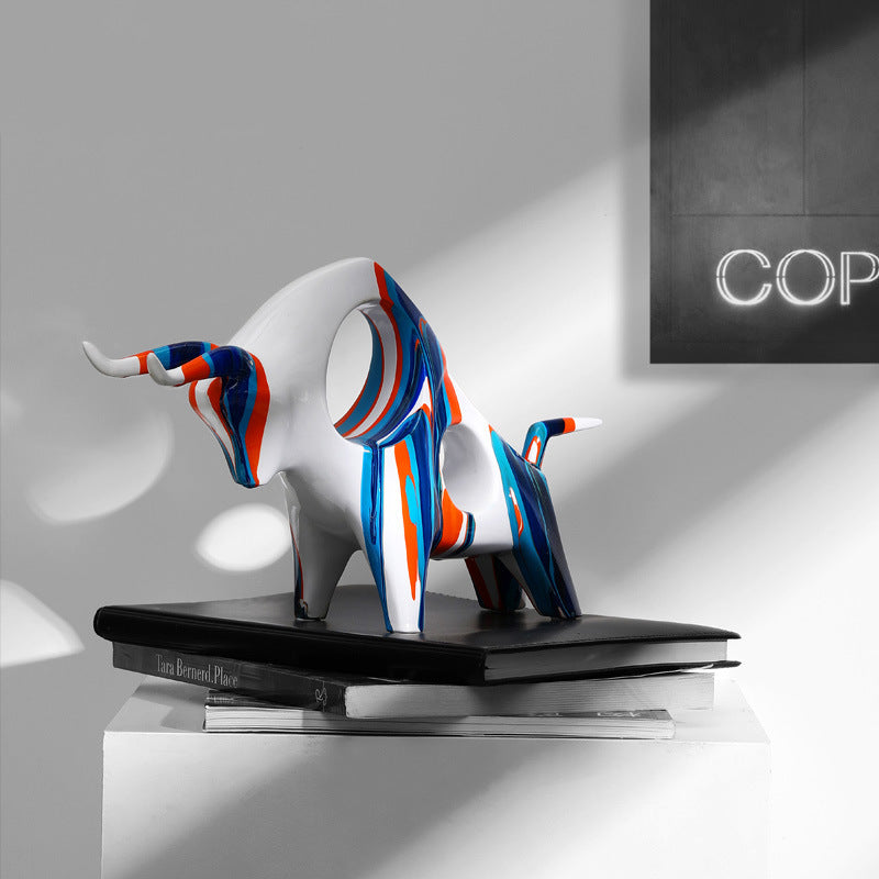 Side view of abstract painted ceramic bull in charging pose