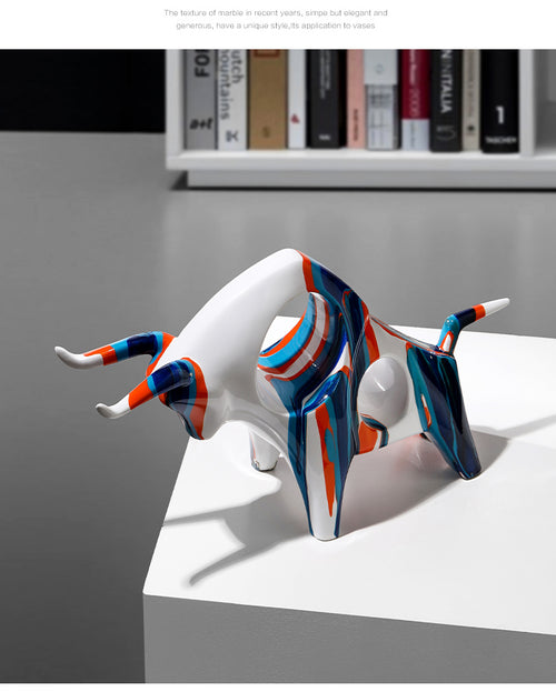 Ceramic bull sculpture with blue and orange artistic finish on books