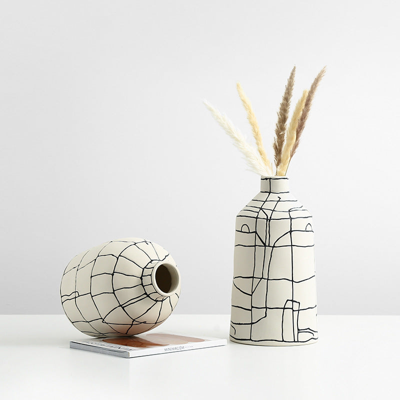 High angle view of tall and short abstract grid ceramic vases