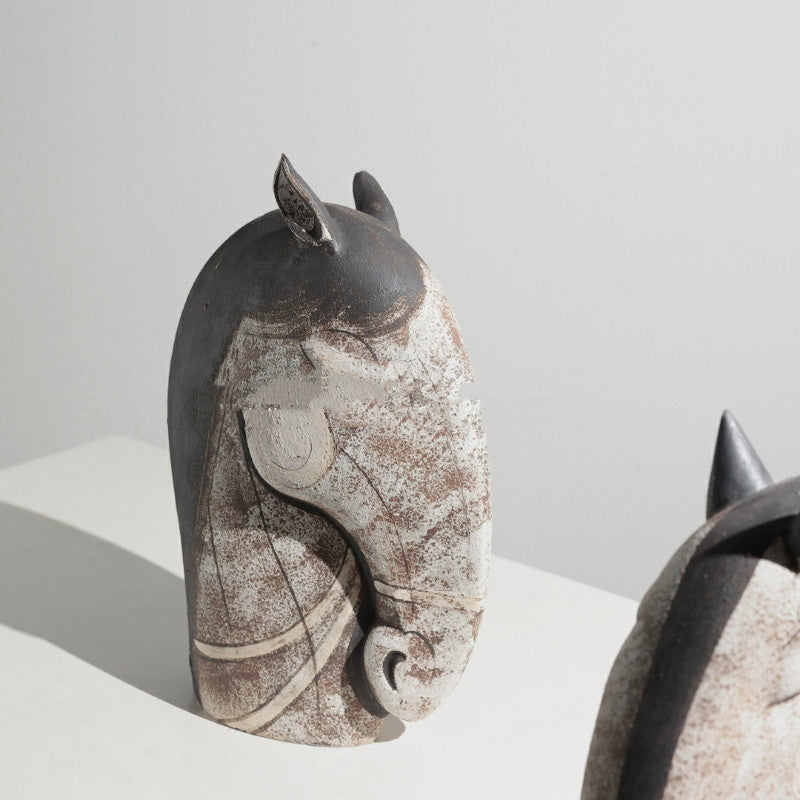 Close up detail of large ceramic horse head sculpture with rustic finish