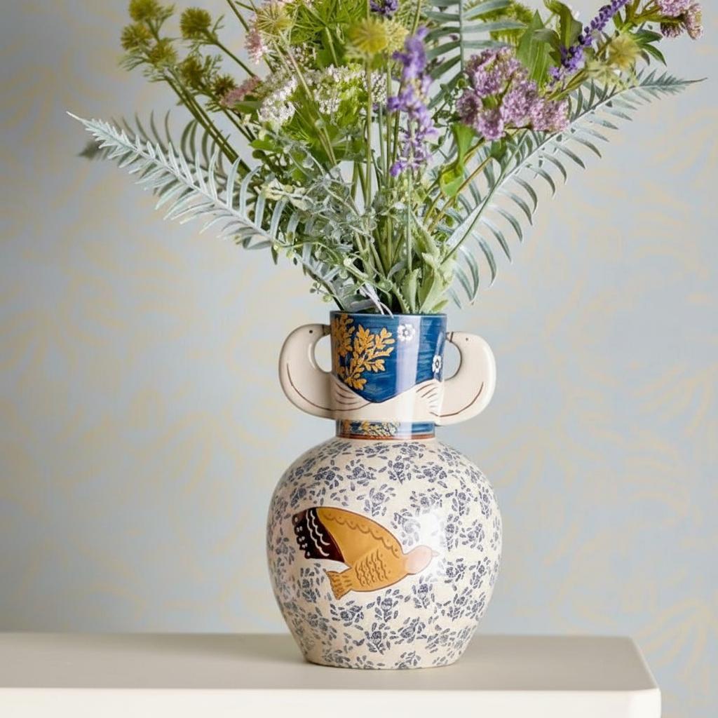 Vase filled with wildflowers on table