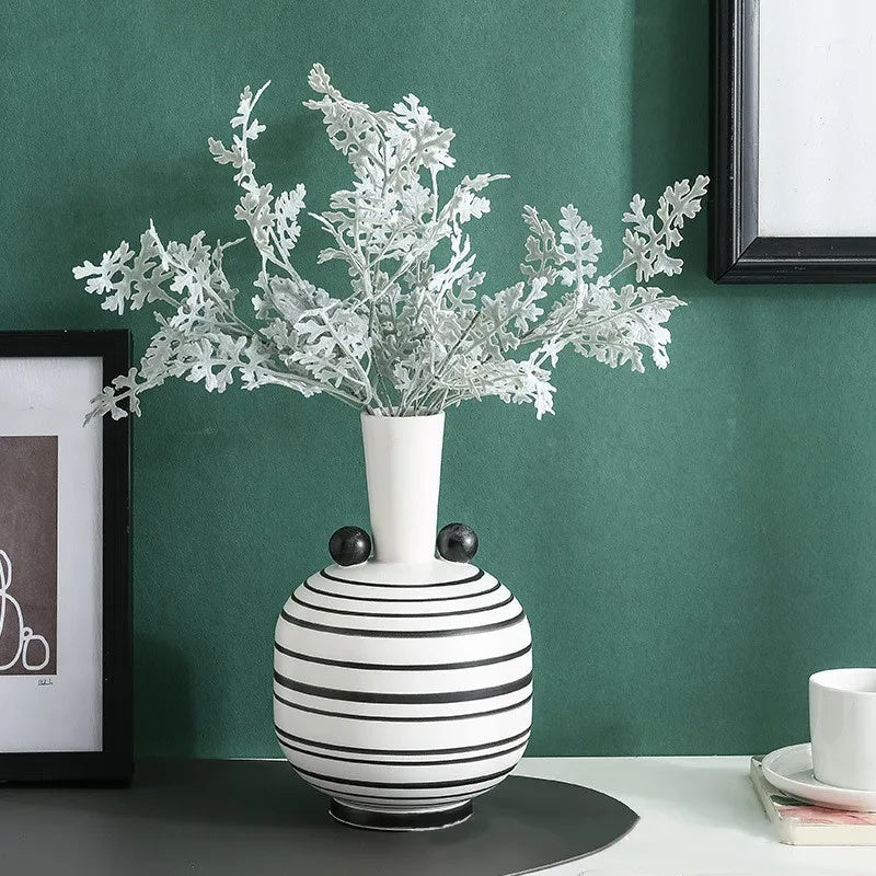 White striped ceramic vase with floral arrangement lifestyle view