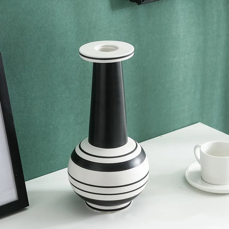 Black and white striped ceramic vase with tall neck