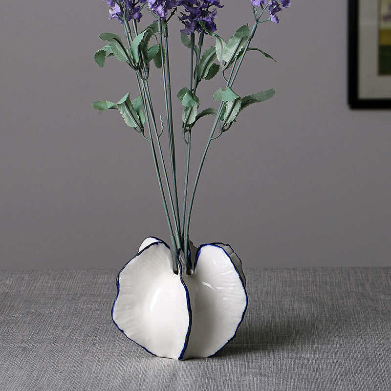 Round white vase with purple flowers