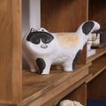 Front view of ceramic cat figurine on shelf