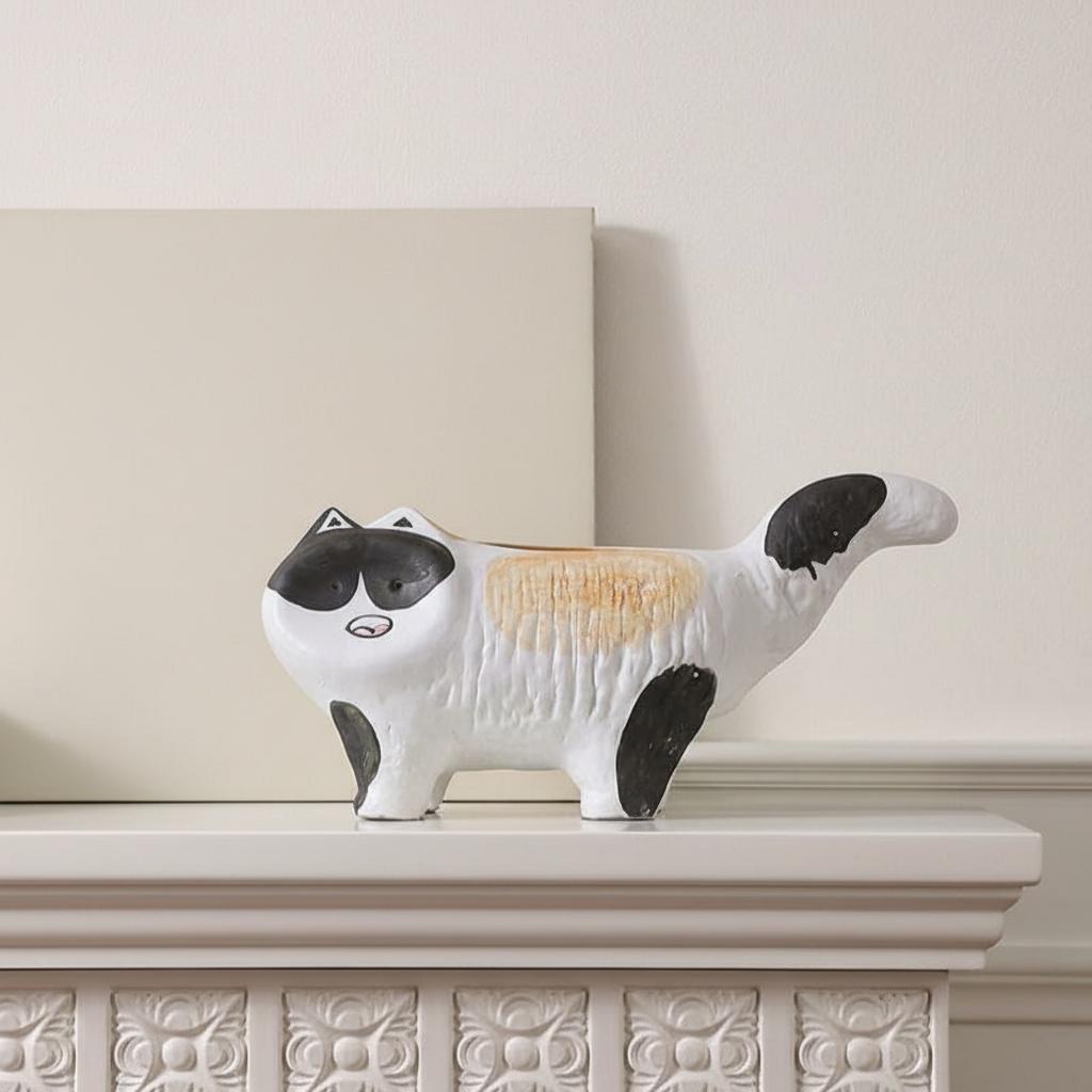 Side profile of ceramic cat statue on mantel