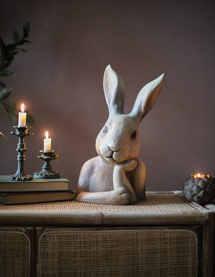 Styled shot of rabbit sculpture on rattan surface