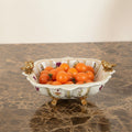 Ceramic crackle glaze bowl with gold bird handles filled with tomatoes