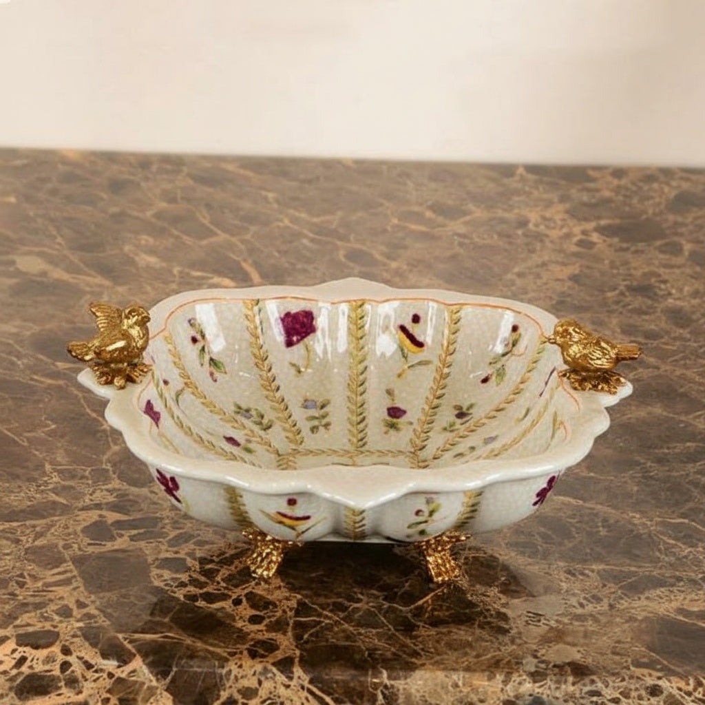 Empty ceramic footed bowl with floral motifs and gold accents