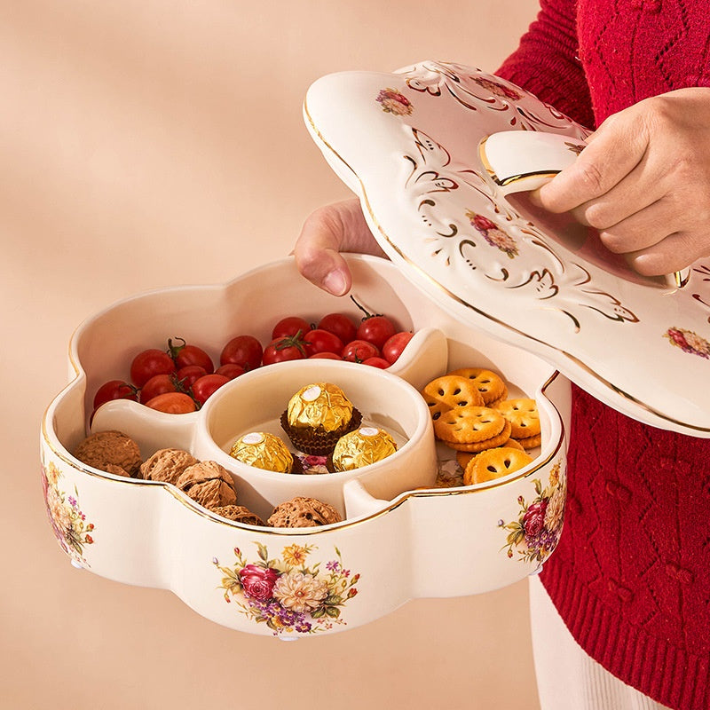 Hand lifting lid of floral ceramic serving dish