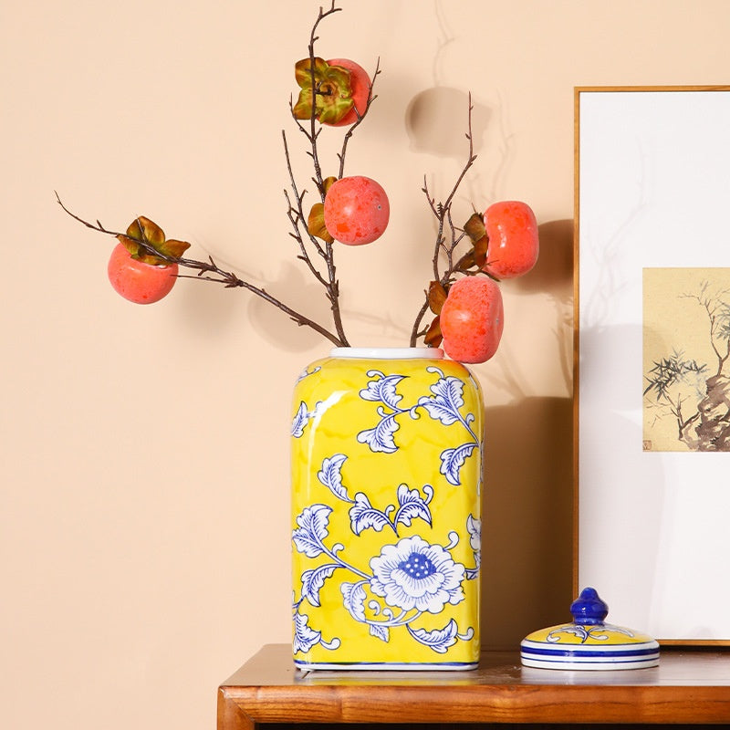 Yellow floral ginger jar styled with persimmon branches