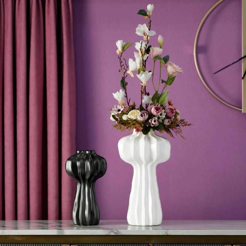 Large white ceramic ribbed vase with pink flowers