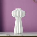 White glossy ceramic sculptural vase solo shot