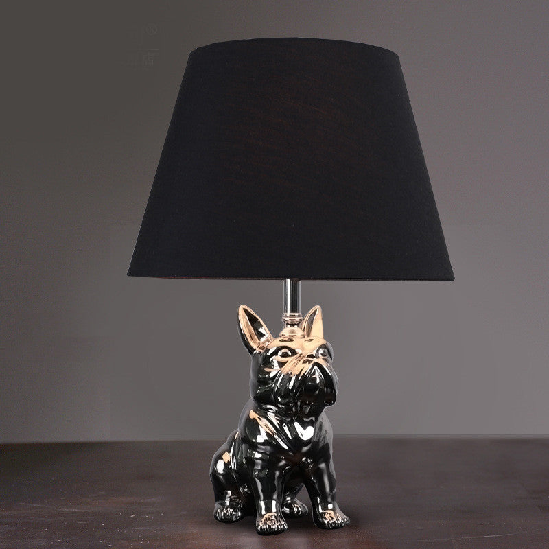 Front view of black and gold ceramic French bulldog table lamp variant