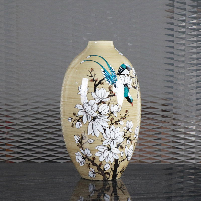 Front view of beige ceramic vase featuring white magnolias and blue birds