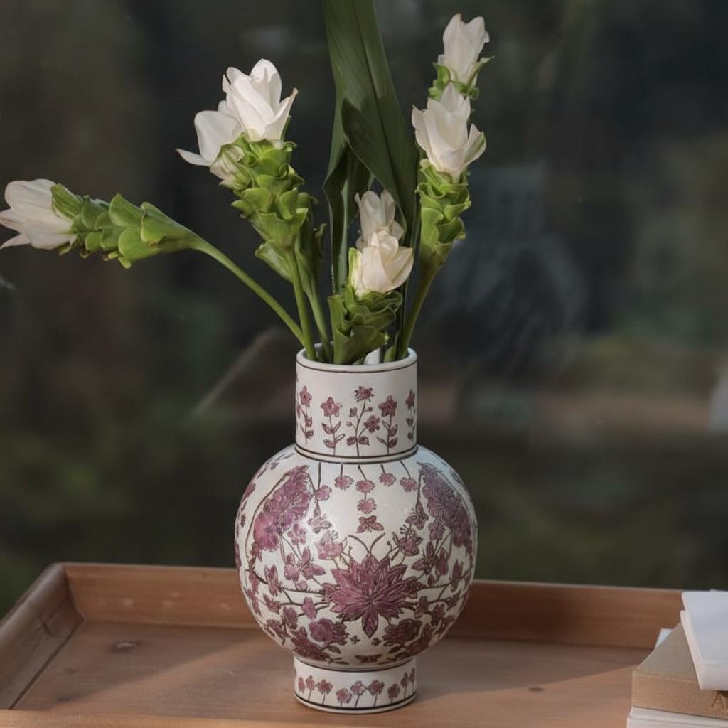 Full view of white and purple ceramic vase holding white flowers
