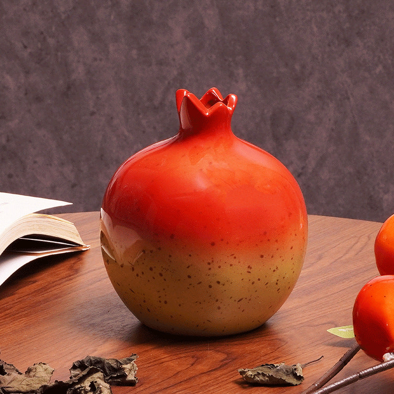 Close up of red and yellow gradient ceramic pomegranate vase