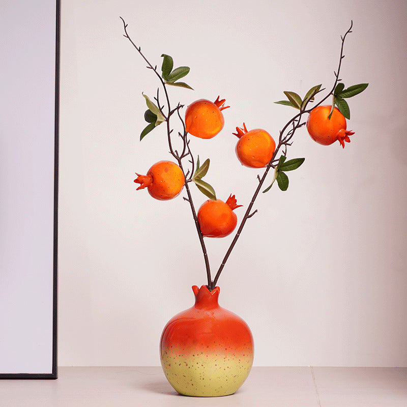 Full view of ceramic fruit shaped vase with stems