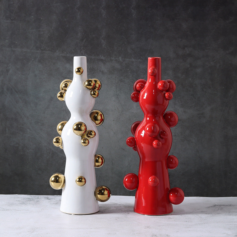 White and red ceramic bubble vases side by side