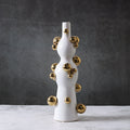 Full view of white and gold sculptural ceramic vase
