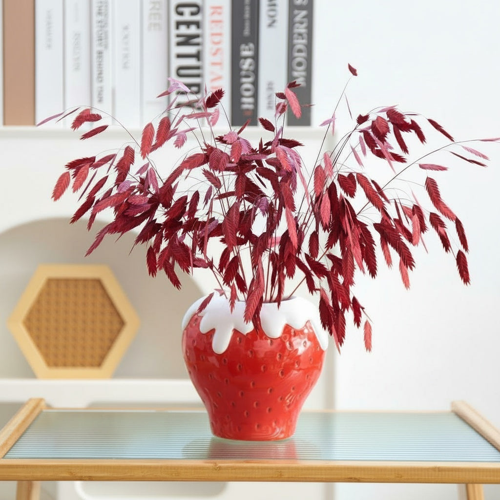 Glazed ceramic strawberry vase with red foliage