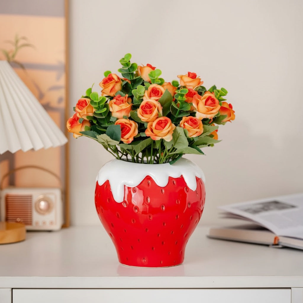 Glazed ceramic strawberry vase with orange roses