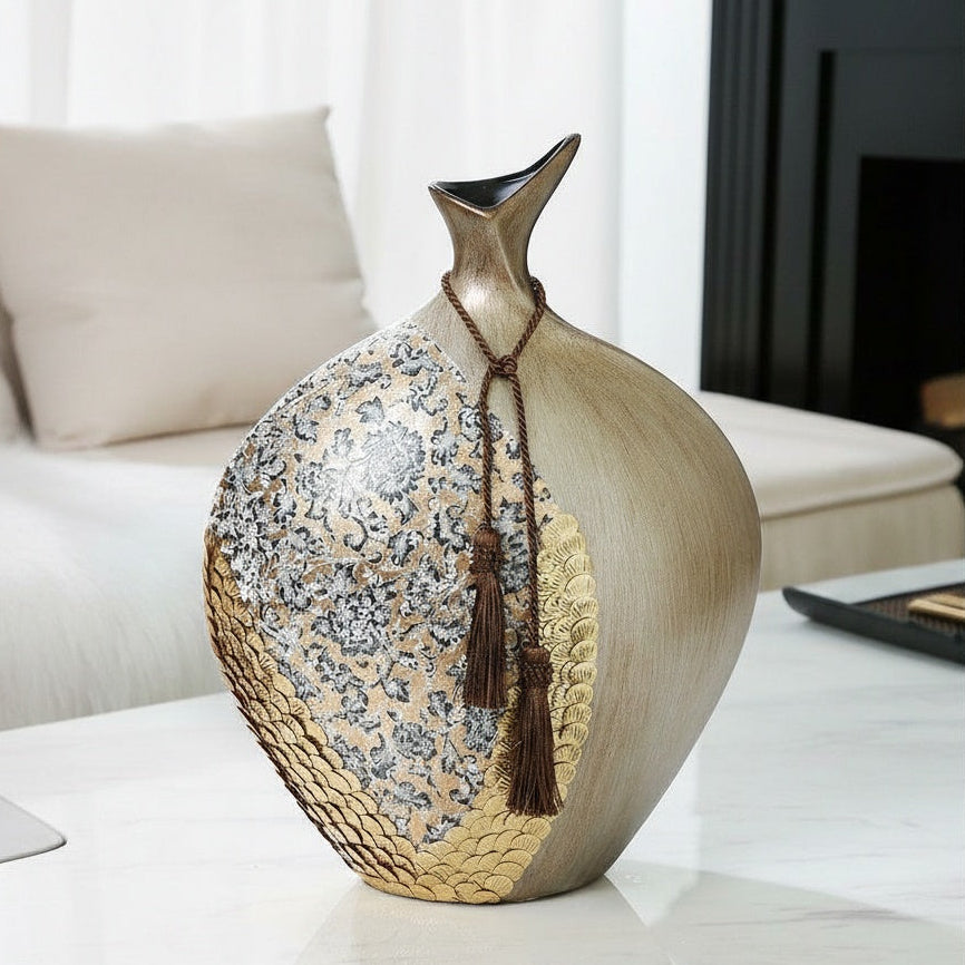 Close up of round champagne gold vase with tassel