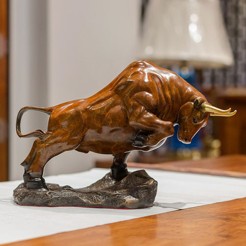 Angled view of resin bull statue with golden horns