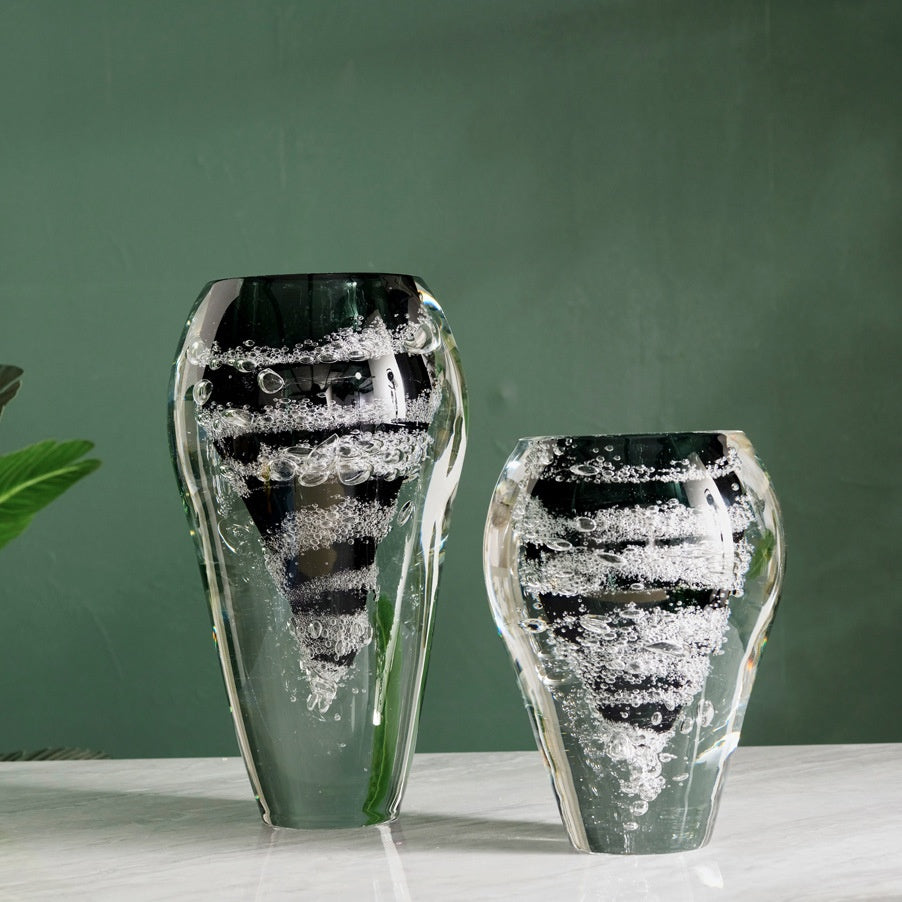 Front view of large and medium black vortex glass vases