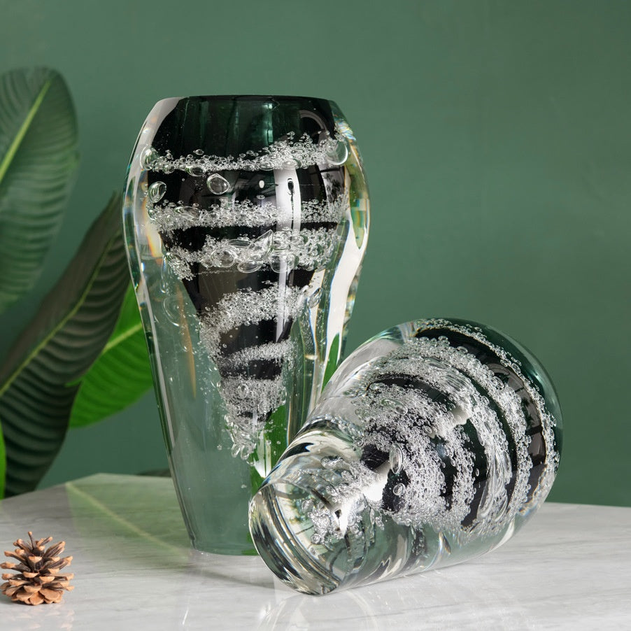 Artistic composition of two bubble glass vases one standing and one lying down
