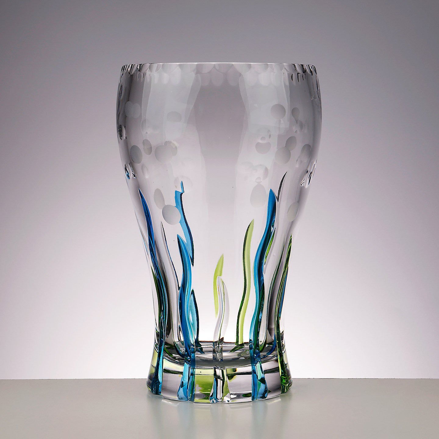 Angled view showing etched bubble details and colored glass ribbons