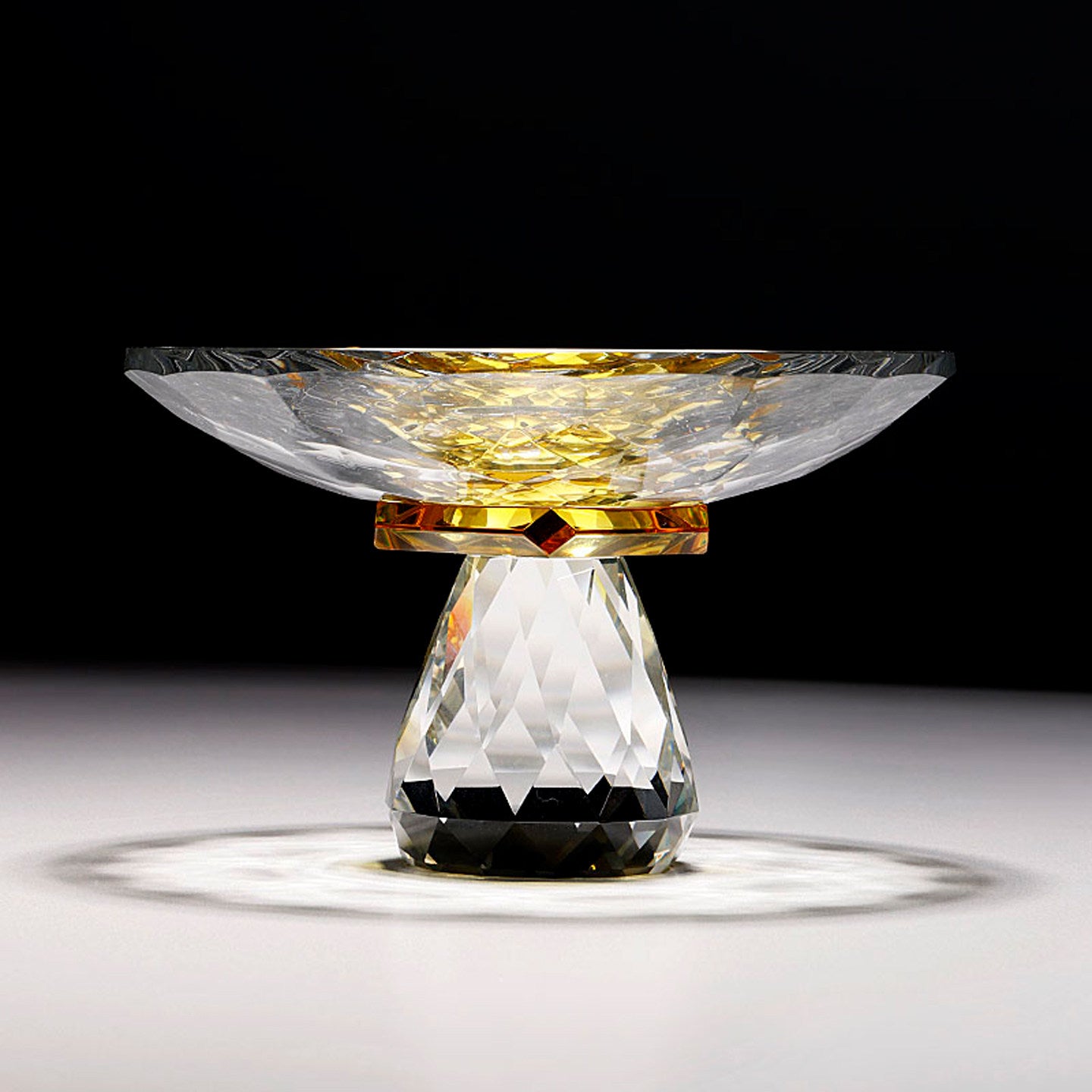 Front view of faceted crystal compote bowl with amber accent