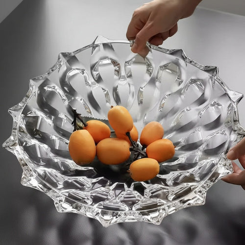 Heavy clear crystal glass fruit bowl filled with oranges for elegant dining table and restaurant decor