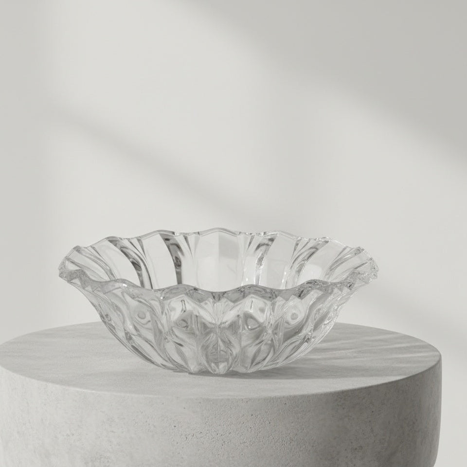 Empty clear crystal glass bowl showing faceted details and scalloped rim