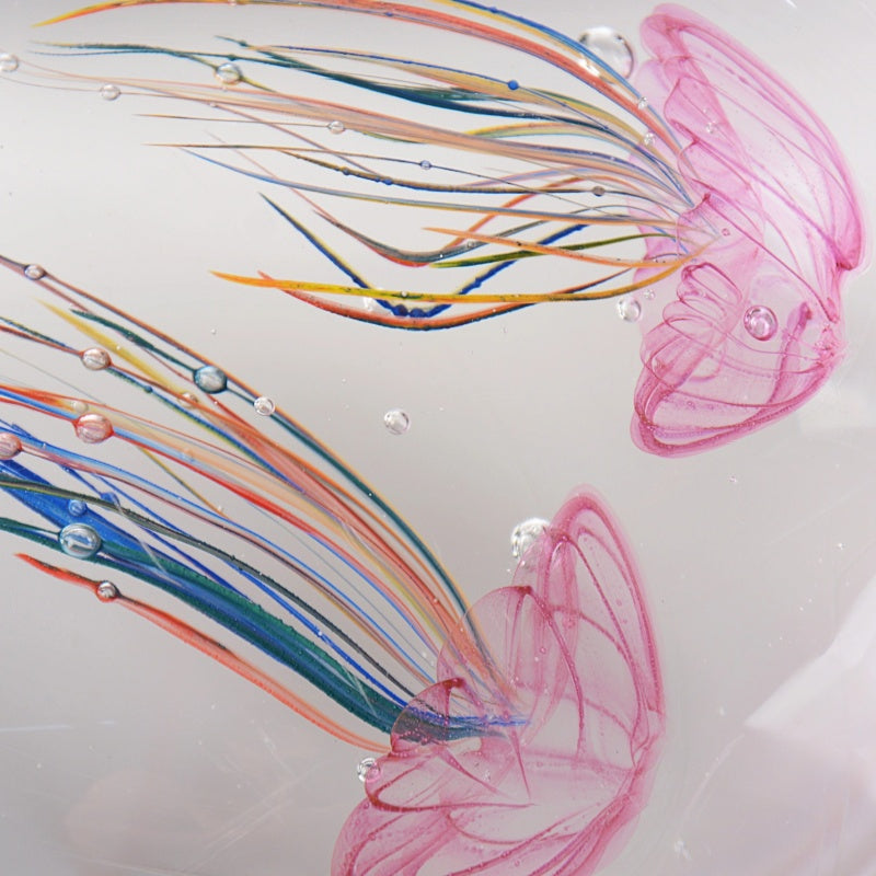 Detail of pink jellyfish tentacles and bubbles in glass