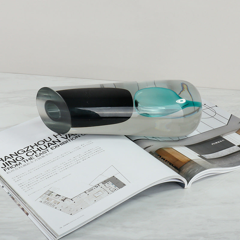 Side view of heavy glass vase on magazine