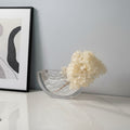 Clear textured glass half-moon vase with white flowers