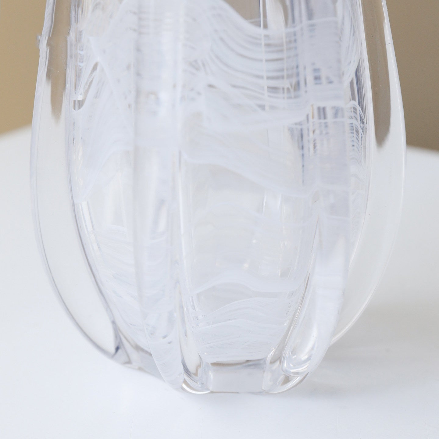 Close up texture of fluted glass and white swirls