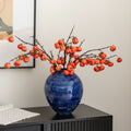Cobalt blue textured ceramic round vase with orange botanicals