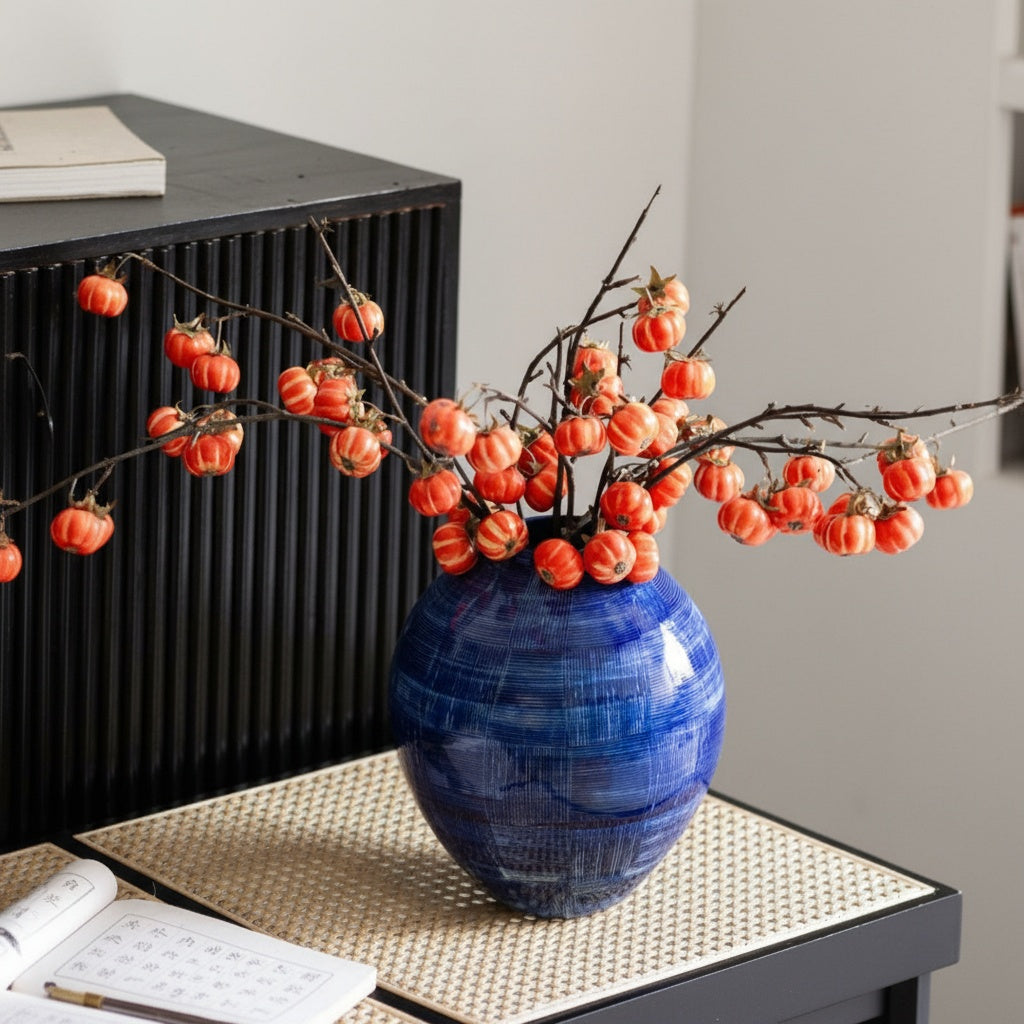 Side view of textured blue vase on console table