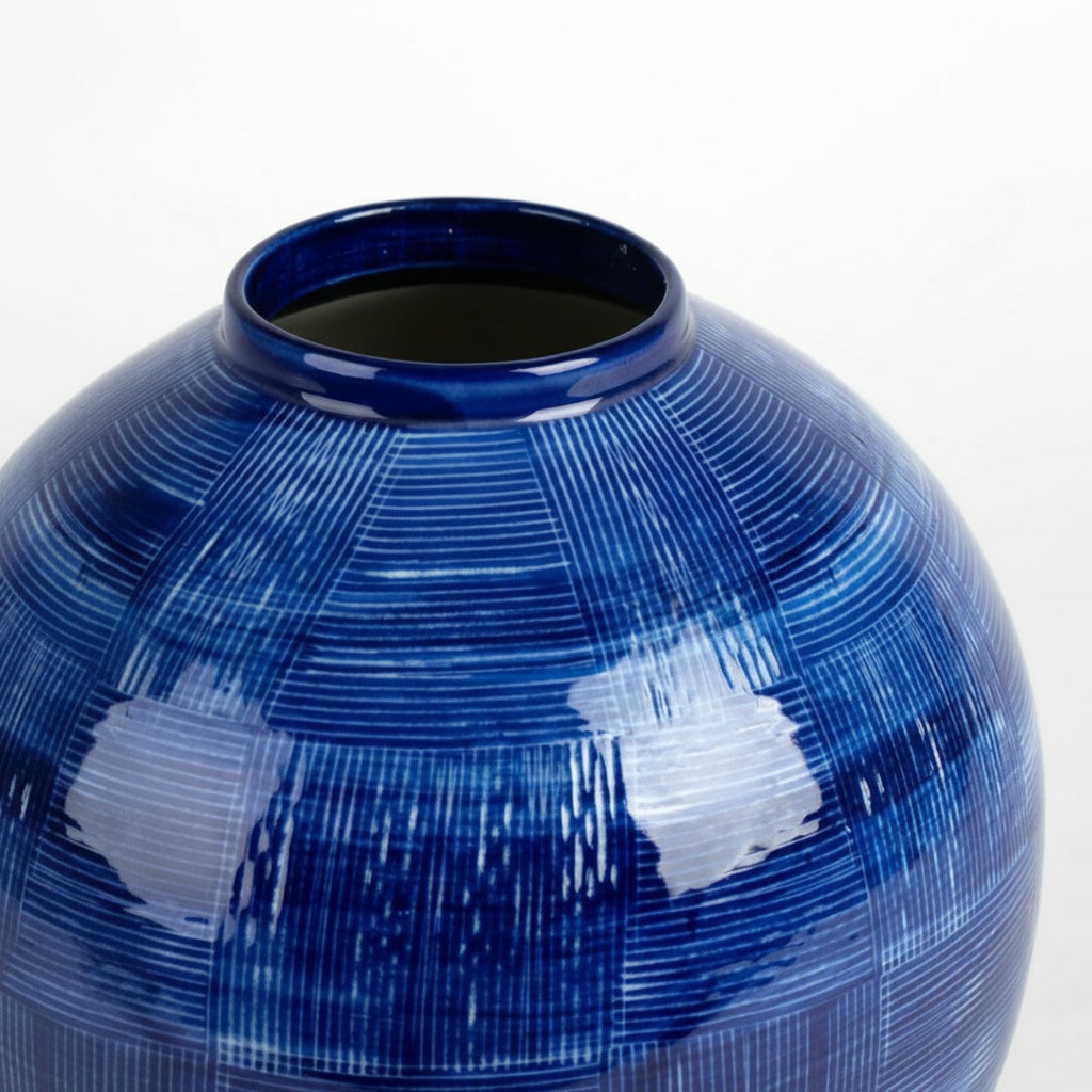 Close up detail of cross-hatch texture on blue ceramic vase