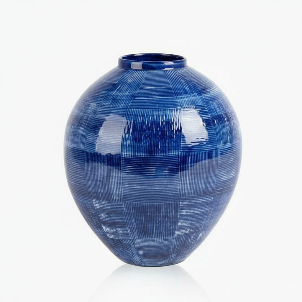 Cobalt blue textured ceramic round vase isolated on white