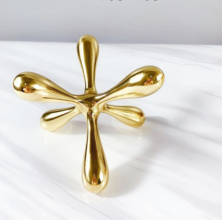 High angle view of large copper ceramic jack sculpture on white marble