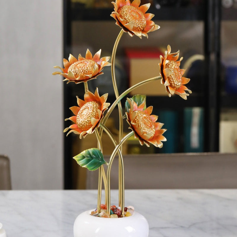 Detail of copper sunflower blooms and white vase