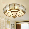 Low angle view of illuminated copper flush mount ceiling light