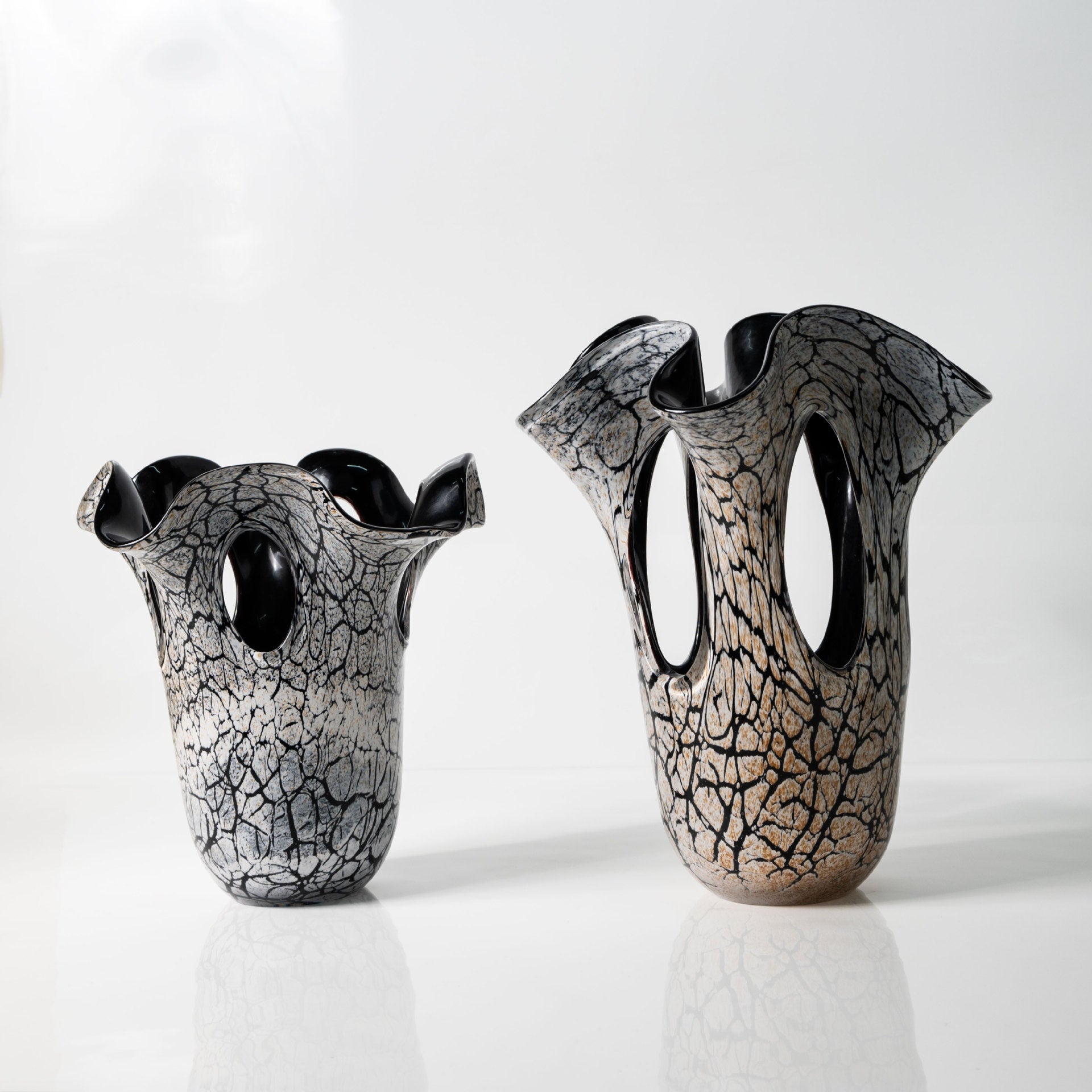 Two crackle glass vases with wavy rims on white background