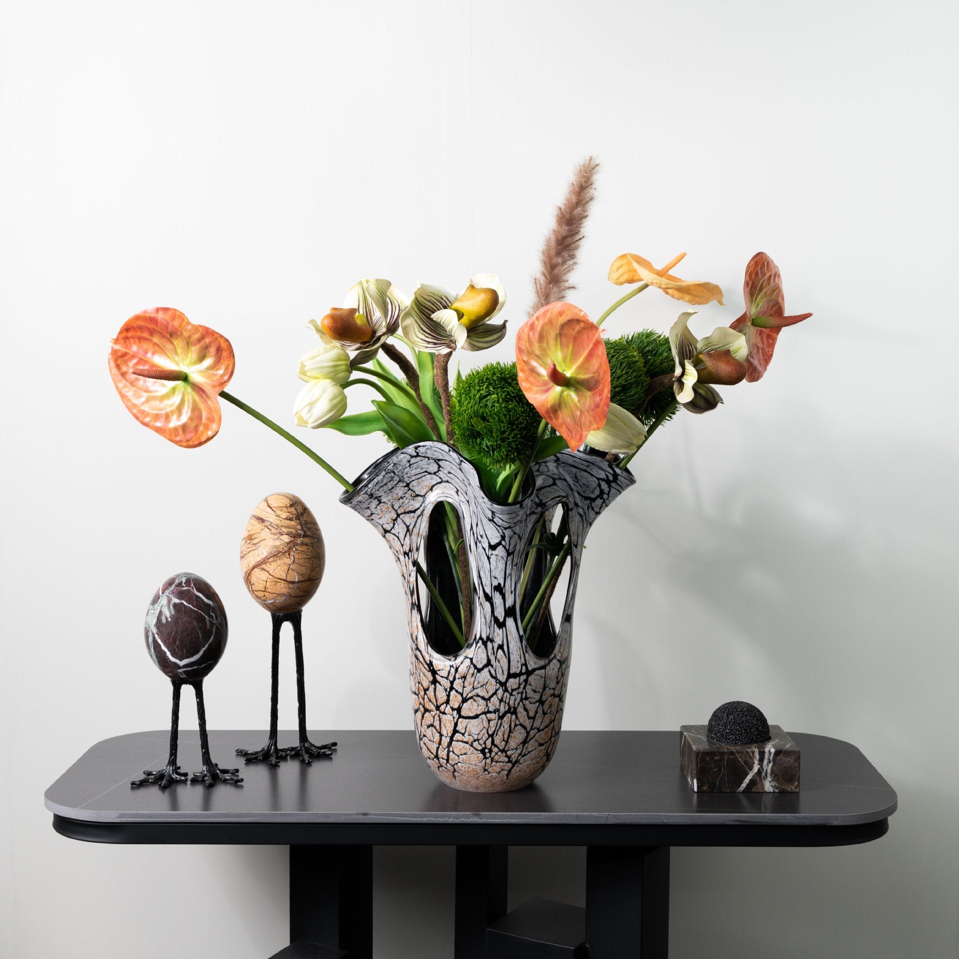 Large amber crackle glass vase with orange floral arrangement