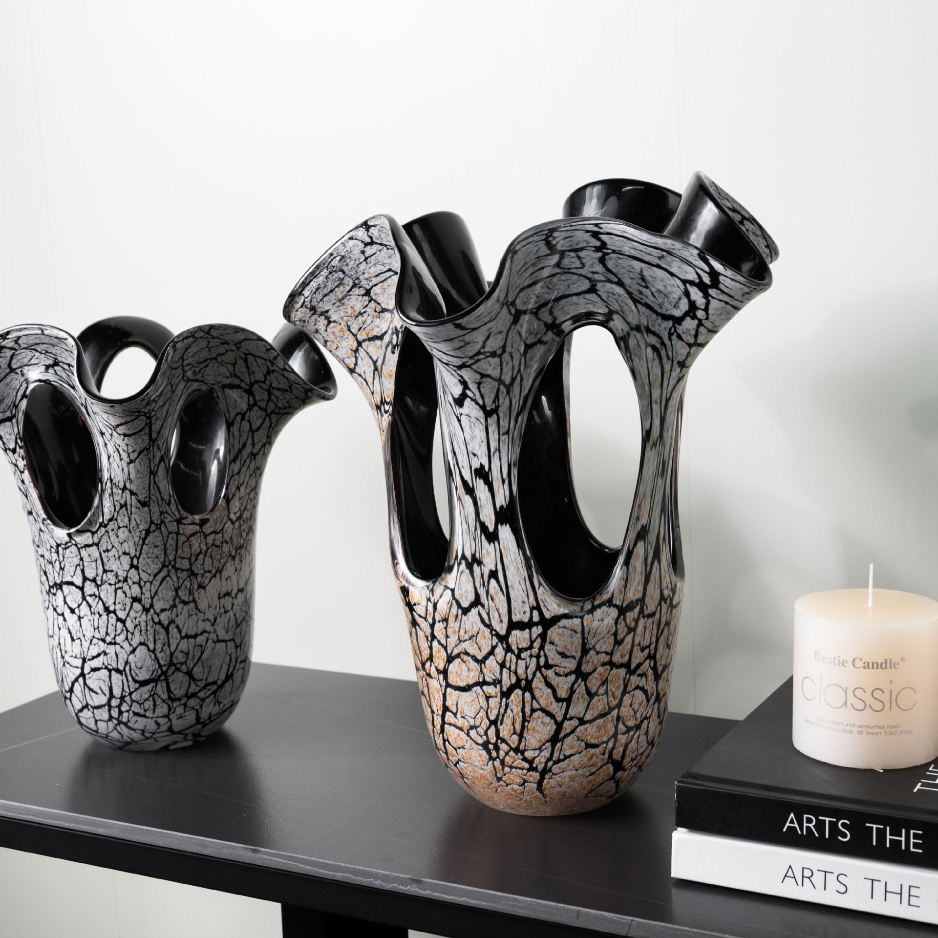Angled view of grey and amber art glass vases showing cutouts