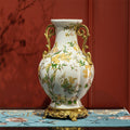 Front view of the ceramic floral vase with brass handles